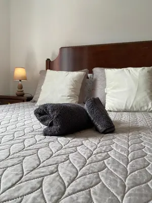 a stuffed animal is laying on a bed at Pana House in Calheta