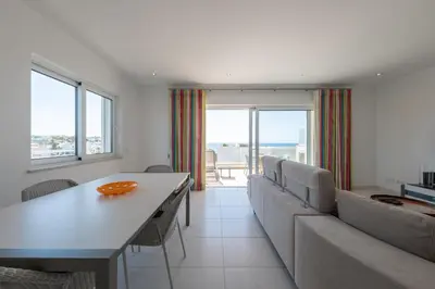 a living room with a couch and a table at Porto de Mos 69 by Destination Algarve in Lagos