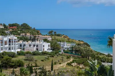 an aerial view of a house on a hill next to the ocean at Porto de Mos 69 by Destination Algarve in Lagos