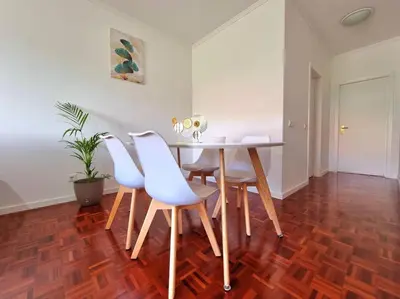 a dining room with a table and four chairs at Junto ao Mar - Apartamento T1 in Santa Cruz