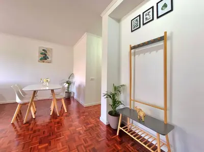 a dining room with a table and a table and chairs at Junto ao Mar - Apartamento T1 in Santa Cruz