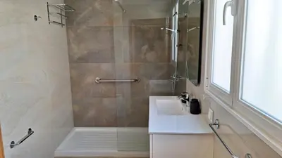 a bathroom with a shower and a white sink at Theo's City House in Funchal