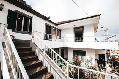 a white house with stairs leading up to it at Casa da Avo Rosa in São Vicente