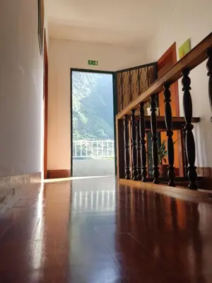 an empty room with a staircase with a large window at Casa da Avo Rosa in São Vicente