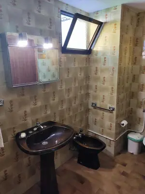 a bathroom with a sink and a toilet at Casa da Avo Rosa in São Vicente