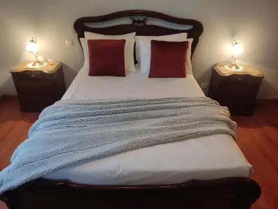 a bedroom with a large bed with two night stands at Brisas do Atlántico in Porto Moniz