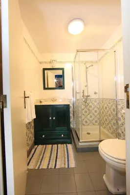 a bathroom with a sink and a shower at Casa do Ribeirinho in Porto Moniz