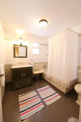 a bathroom with a sink and a toilet and a tub at Casa do Ribeirinho in Porto Moniz
