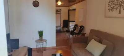 a living room with a couch and a table at Casa das Vistas in Porto Moniz