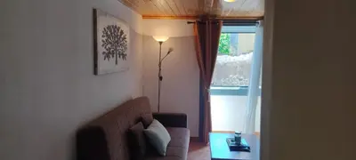 a living room with a couch and a window at Casa das Vistas in Porto Moniz