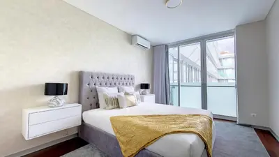 a bedroom with a large bed and a large window at Upscale Apartment by LovelyStay in Funchal