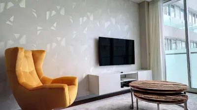 a living room with a chair and a television at Upscale Apartment by LovelyStay in Funchal
