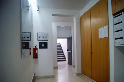 a hallway of a building with a staircase and a room at Studio no centro do Funchal in Funchal