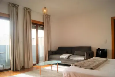 a living room with a couch and a table at Studio no centro do Funchal in Funchal