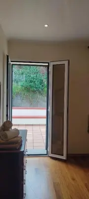 an empty room with an open door to a patio at Casa da Montanha in Salão