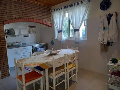 a kitchen with a table and chairs in a room at Casa da Montanha in Salão