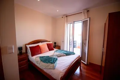 a bedroom with a bed with orange pillows at Casa da Montanha in Salão