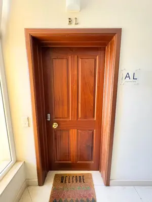 a wooden door in a room with a rug at LIDO CASA BRANCA in Funchal