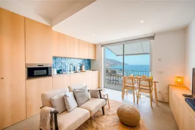 a living room with a couch and a view of the ocean at Jasmineiro Mar - Ocean View Studio in Funchal