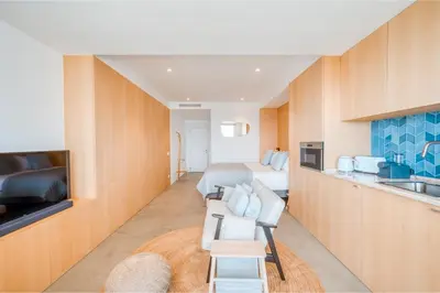 a hotel room with a bed and a kitchen at Jasmineiro Mar - Ocean View Studio in Funchal