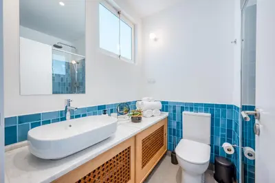 a bathroom with a white sink and a toilet at Jasmineiro Mar - Ocean View Studio in Funchal