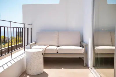 a couch sitting on a balcony next to a window at Jasmineiro Mar - Ocean View Studio in Funchal