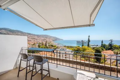 a balcony with chairs and a view of the ocean at Jasmineiro Serra - Ocean View Studio in Funchal