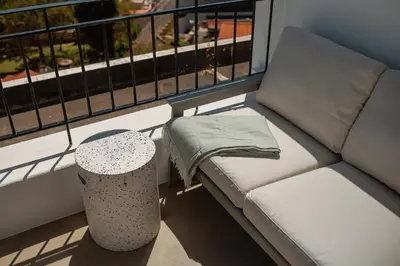 a couch sitting on a balcony with a table at Jasmineiro Serra - Ocean View Studio in Funchal