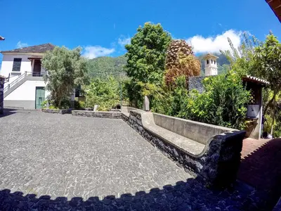 a stone bench sitting in the middle of a courtyard at Mountain View Villa in São Vicente