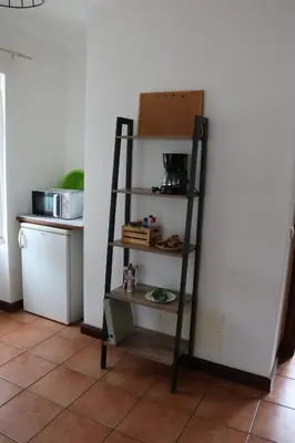 a shelf in a kitchen next to a refrigerator at Mountain View Villa in São Vicente