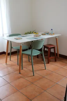 a table with two chairs and a white table and a table and chairs at Mountain View Villa in São Vicente