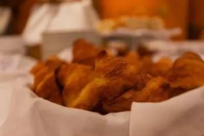 a basket filled with fried food on a table at BIO Hotel - Hotel Quinta da Serra in Estreito de Câmara de Lobos