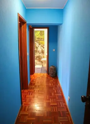 a hallway with blue walls and a wooden floor at Funchal downtown 5min Marina + 2 bedroom + parking in Funchal
