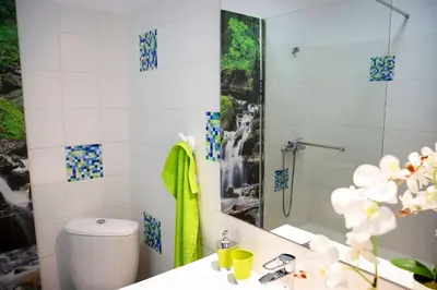 a bathroom with a shower and a toilet and a sink at Funchal downtown 5min Marina + 2 bedroom + parking in Funchal