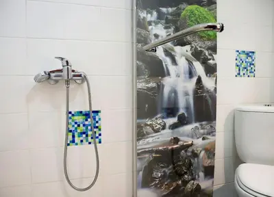 a bathroom with a shower with a painting on the wall at Funchal downtown 5min Marina + 2 bedroom + parking in Funchal