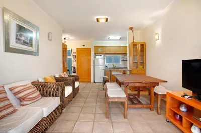 a living room with a couch and a table at Energia Dourada - Porto Santo in Porto Santo