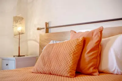 a bedroom with a bed with two nightstands and two lamps at Energia Dourada - Porto Santo in Porto Santo