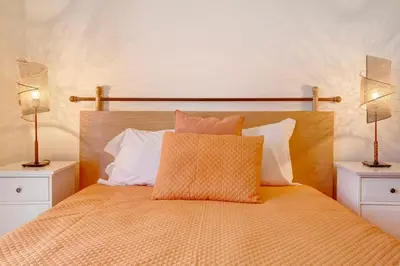 a hotel room with a bed with towels on it at Energia Dourada - Porto Santo in Porto Santo
