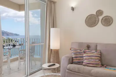 a living room with a couch and a balcony at Apartamento do Mar II by An Island Apart in Funchal