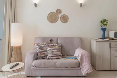 a couch with two pillows on it in a living room at Apartamento do Mar II by An Island Apart in Funchal