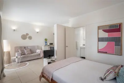 a white bedroom with a bed and a couch at Apartamento do Mar II by An Island Apart in Funchal