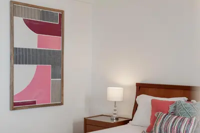 a bedroom with a bed and a painting on the wall at Apartamento do Mar II by An Island Apart in Funchal