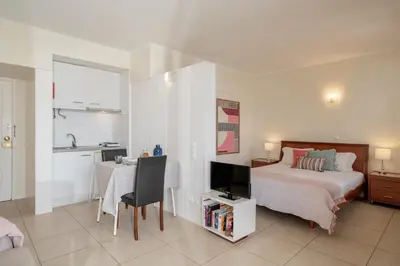 a bedroom with a bed and a desk with a tv at Apartamento do Mar II by An Island Apart in Funchal