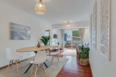 a dining room and living room with a table and chairs at Tropical Pearl by Atlantic Holiday in Funchal