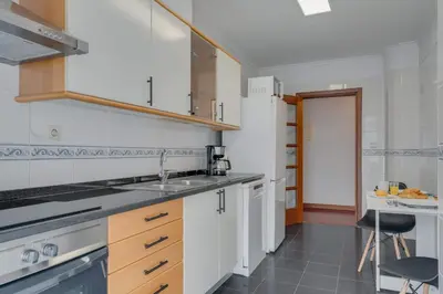 a kitchen with white cabinets and a sink at Tropical Pearl by Atlantic Holiday in Funchal