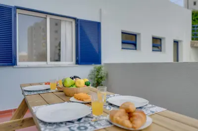 a table with plates of food and fruit on it at Tropical Pearl by Atlantic Holiday in Funchal