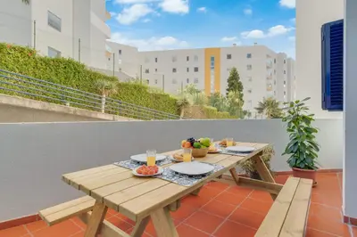 a wooden table on a balcony with food on it at Tropical Pearl by Atlantic Holiday in Funchal