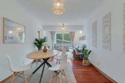 a dining room and living room with a table and chairs at Tropical Pearl by Atlantic Holiday in Funchal