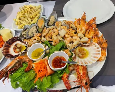 a plate of food with seafood and other foods at Lua do Mar in Caniço