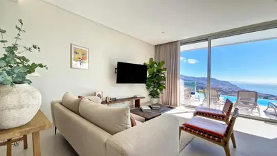 a living room with a couch and a large window at Villa Obra-Prima by LovelyStay in Funchal